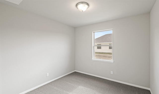 carpeted spare room with baseboards
