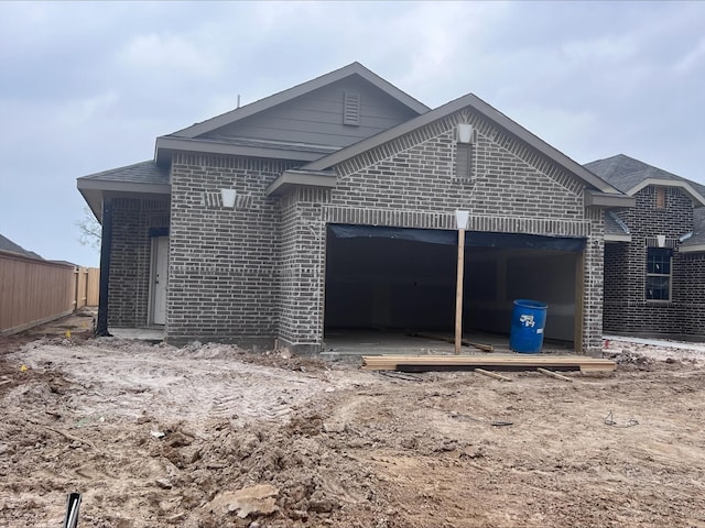 view of side of property with brick siding and an attached garage