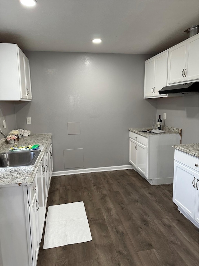 kitchen featuring dark hardwood / wood-style flooring, sink, and white cabinets