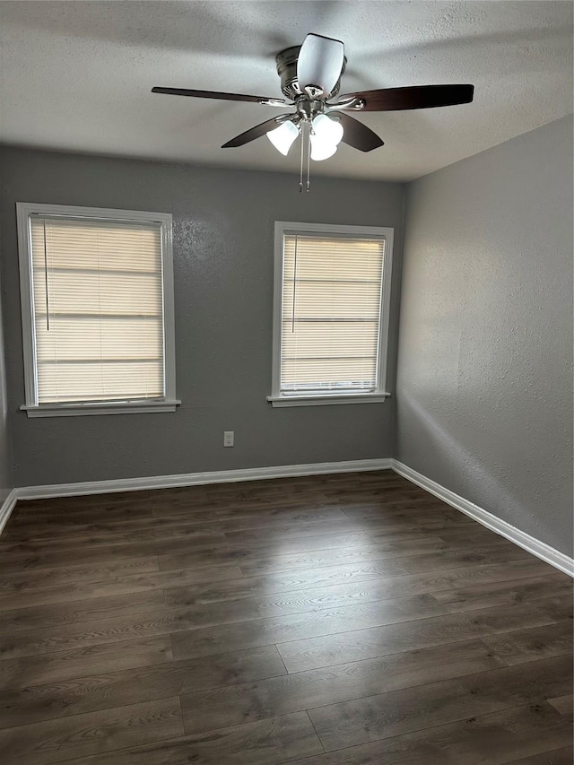 unfurnished room with ceiling fan, dark hardwood / wood-style flooring, and a textured ceiling