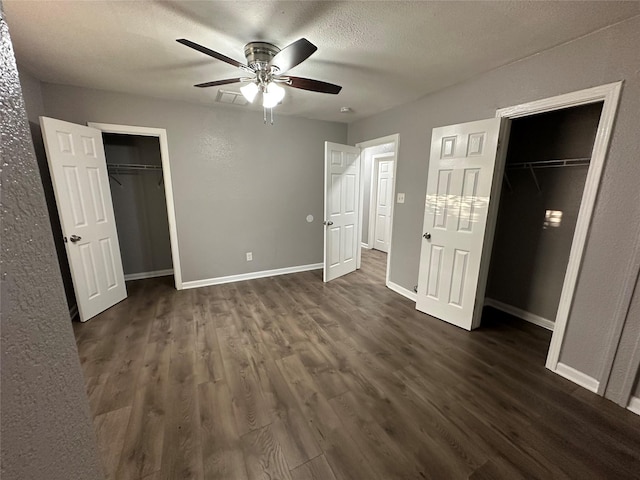 unfurnished bedroom featuring ceiling fan, dark hardwood / wood-style floors, and a textured ceiling