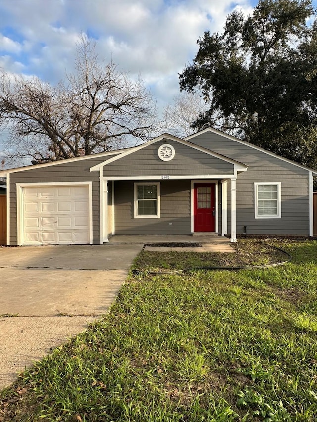 ranch-style house featuring a front lawn and a garage