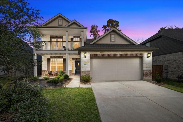 view of front of home with a balcony and a garage