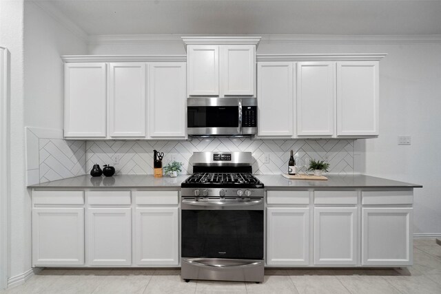 kitchen featuring white cabinets, ornamental molding, and stainless steel appliances