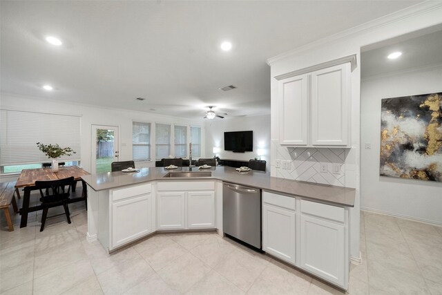 kitchen with stainless steel dishwasher, white cabinets, and sink