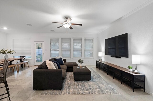 tiled living room featuring ceiling fan and ornamental molding