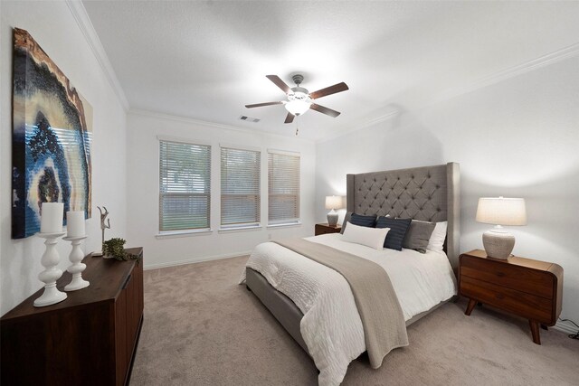 carpeted bedroom with ceiling fan and ornamental molding