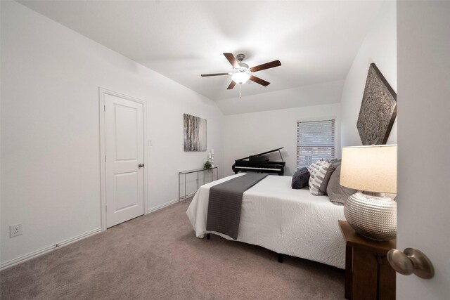 bedroom with ceiling fan, lofted ceiling, and carpet floors