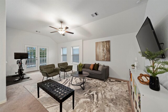 living room featuring french doors, light colored carpet, ceiling fan, and lofted ceiling