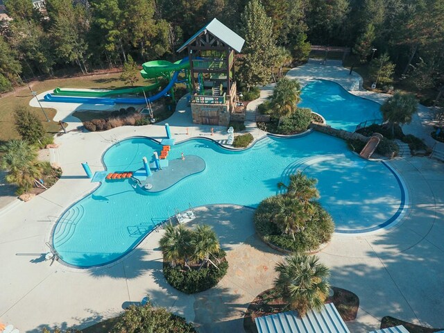 view of swimming pool featuring a playground