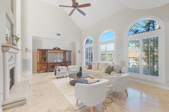 living room featuring ceiling fan and high vaulted ceiling