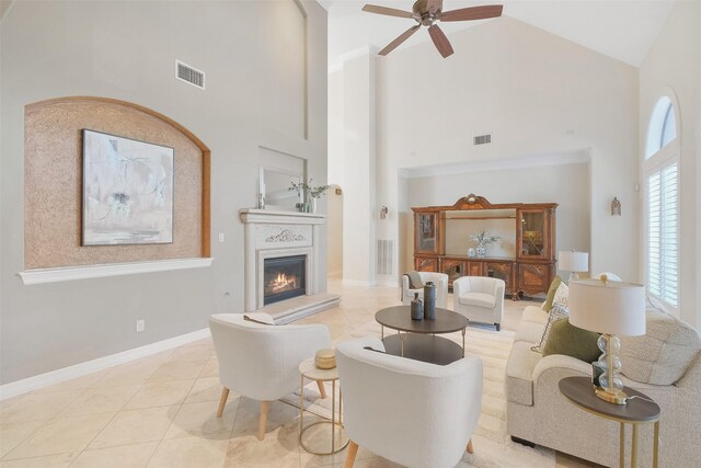 living room with high vaulted ceiling, ceiling fan, and light tile patterned flooring