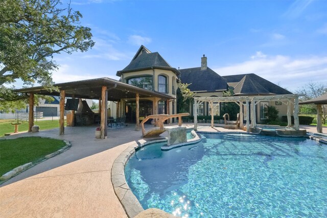 view of pool featuring an in ground hot tub, an outdoor kitchen, and a patio