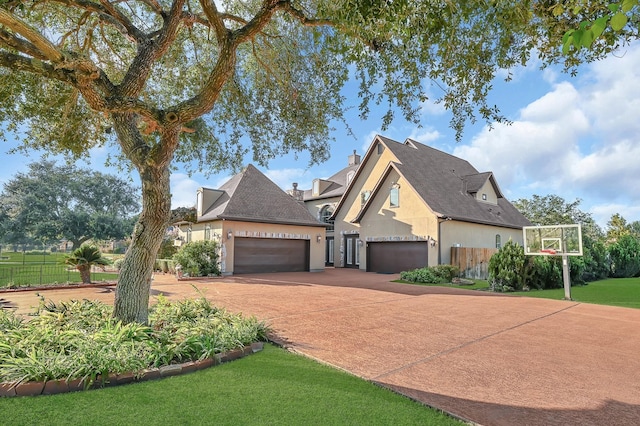 view of front of house featuring a garage and a front lawn