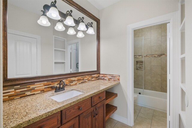 bathroom with tile patterned floors, decorative backsplash, vanity, and tiled shower / bath combo