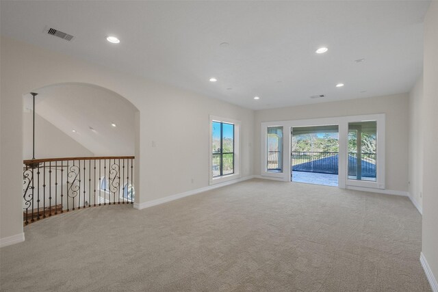 unfurnished room featuring light carpet