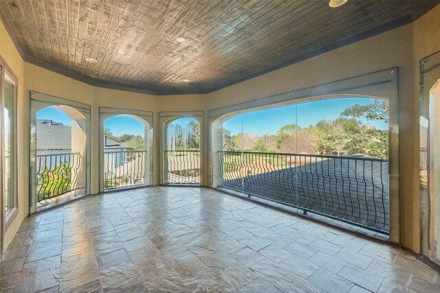 unfurnished sunroom with wood ceiling