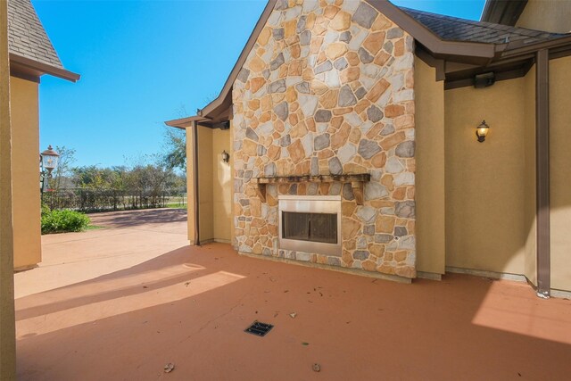 view of patio / terrace featuring an outdoor fireplace