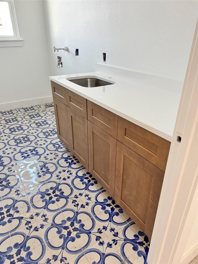 bathroom with tile patterned flooring and sink