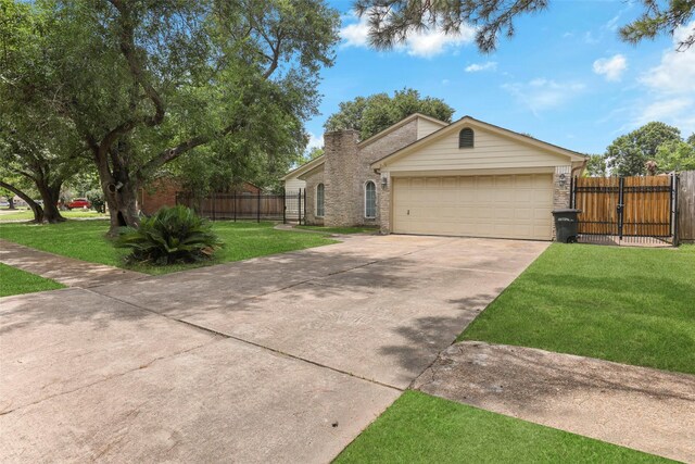 single story home featuring a garage and a front lawn