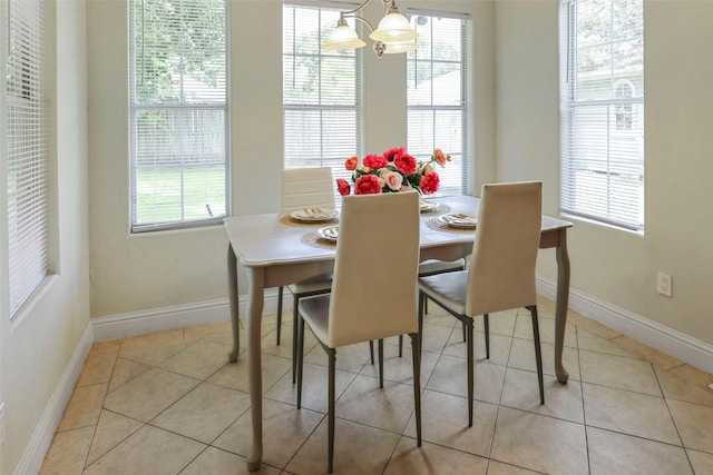 tiled dining space featuring a notable chandelier