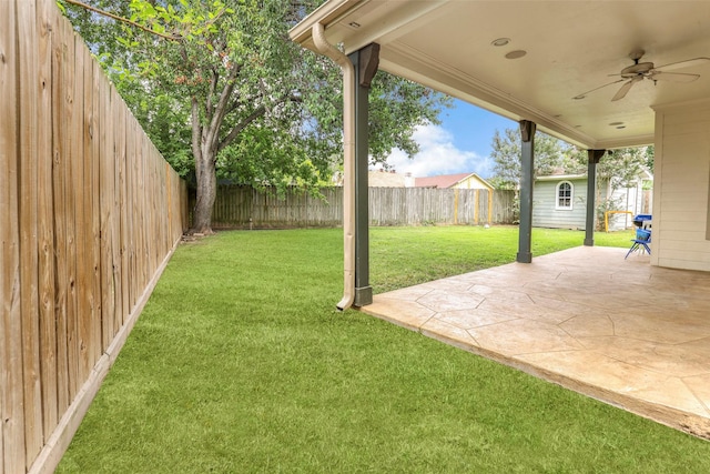 view of yard featuring a patio and ceiling fan