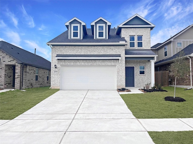 view of front of property featuring a garage and a front yard