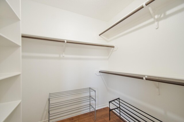 walk in closet featuring dark hardwood / wood-style flooring