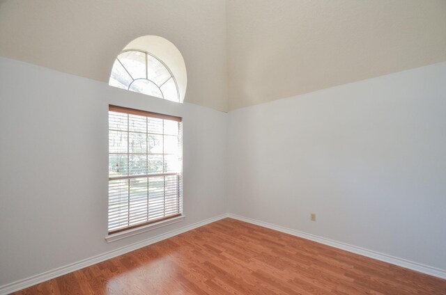 unfurnished room featuring hardwood / wood-style floors and a wealth of natural light