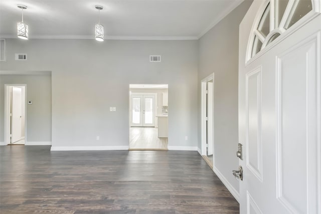 interior space with dark hardwood / wood-style flooring and ornamental molding