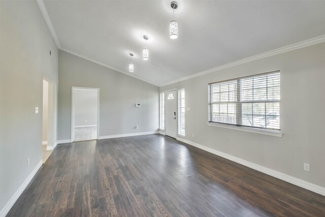 empty room with high vaulted ceiling, dark hardwood / wood-style floors, and crown molding