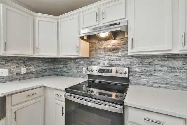 kitchen with stainless steel electric stove, white cabinets, and tasteful backsplash