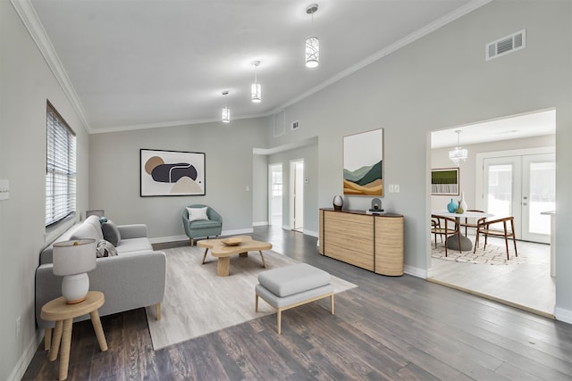 living room with french doors, vaulted ceiling, crown molding, and hardwood / wood-style flooring