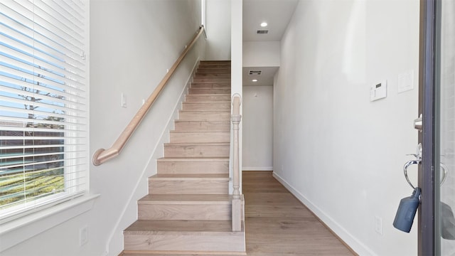 staircase with hardwood / wood-style floors