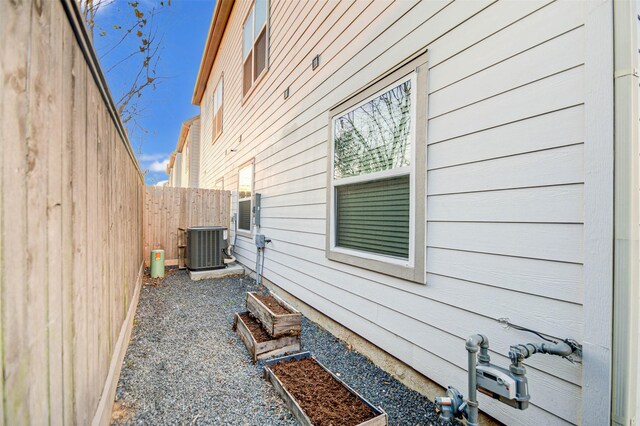 view of side of home featuring central AC unit