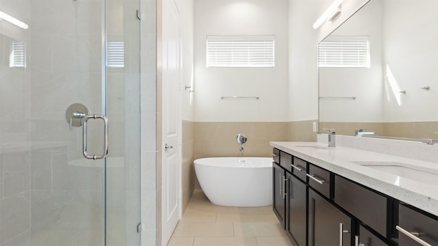 bathroom featuring vanity, tile patterned flooring, and plus walk in shower