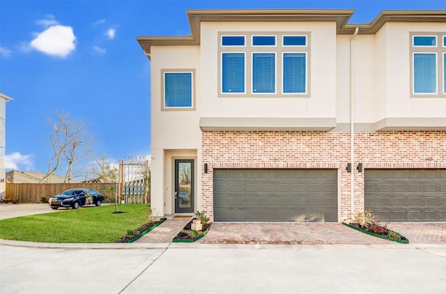 view of front facade with a garage and a front lawn