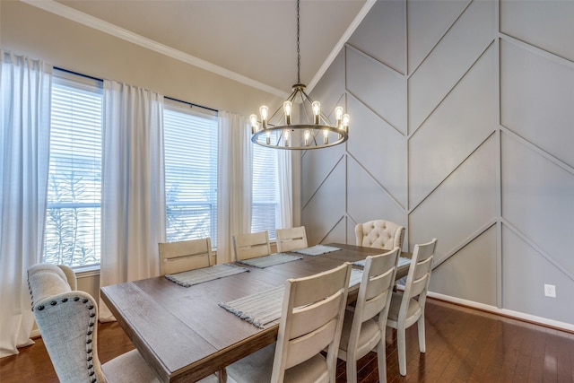 dining area with dark hardwood / wood-style flooring, crown molding, and a notable chandelier