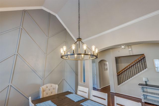 dining room featuring crown molding, wood-type flooring, vaulted ceiling, and a notable chandelier