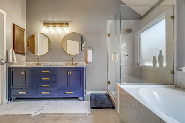 bathroom with tile patterned floors, vanity, and shower with separate bathtub