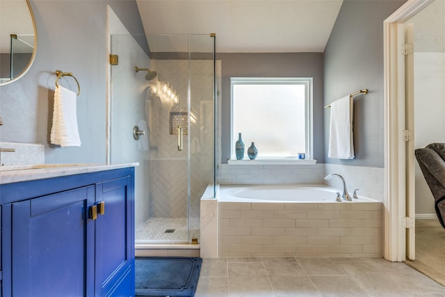 bathroom featuring tile patterned floors, vanity, and shower with separate bathtub