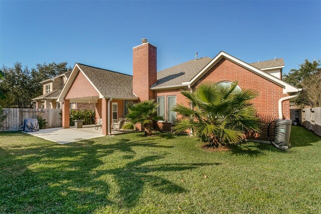 back of property featuring a patio area and a lawn