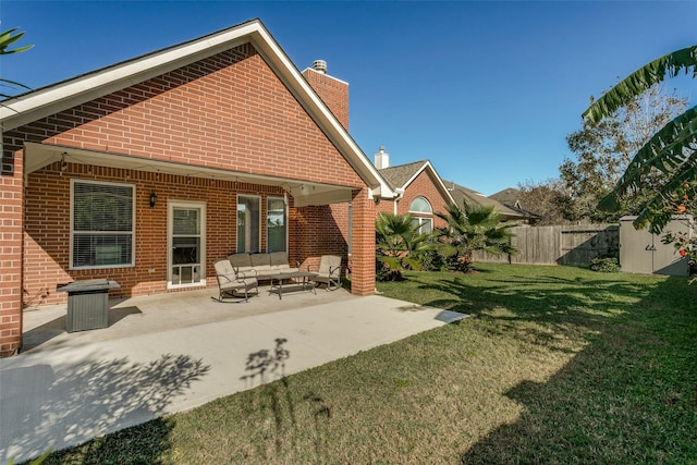 back of house with a lawn, a patio area, and an outdoor hangout area