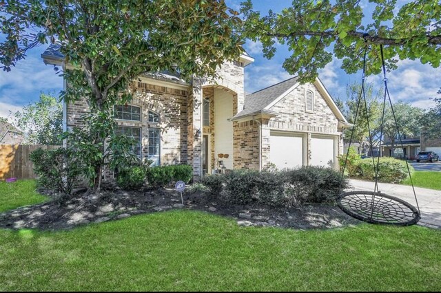 view of front of home featuring a garage and a front lawn