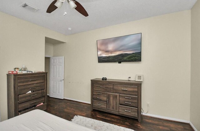 bedroom with ceiling fan and dark hardwood / wood-style floors