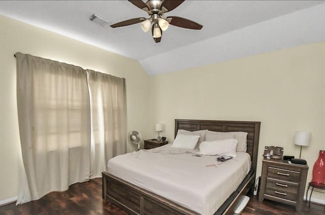 bedroom with ceiling fan, dark hardwood / wood-style flooring, and vaulted ceiling