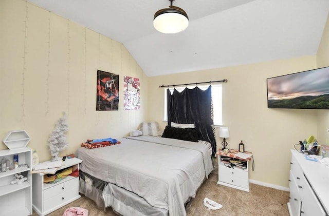 carpeted bedroom featuring lofted ceiling