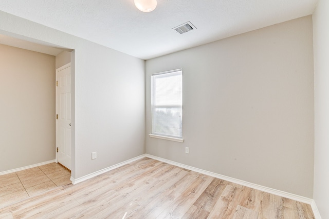 unfurnished room with light hardwood / wood-style flooring