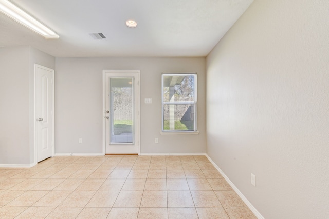 spare room with light tile patterned floors