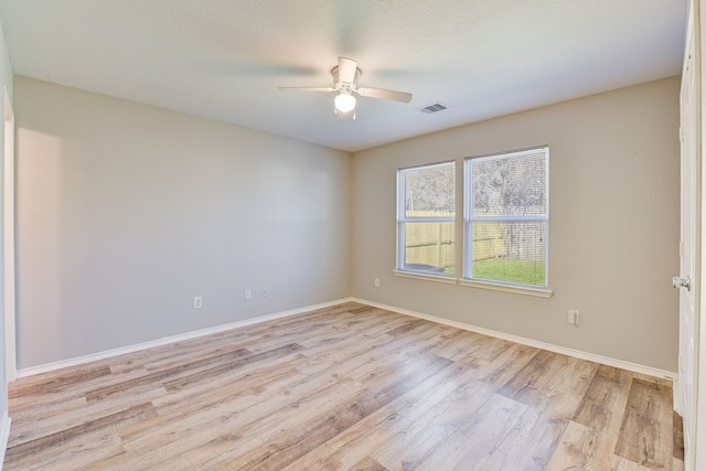 empty room featuring ceiling fan and light wood-type flooring